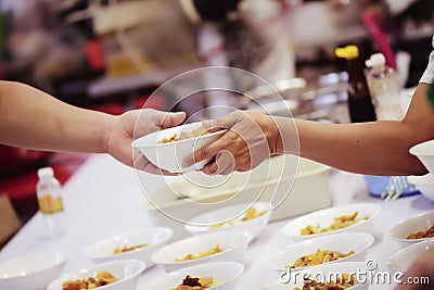 The hands of the rich give food to the hands of the poor. Concept: The concept of sharing Stock Photo