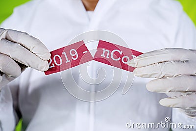 Hands ripping text of 2019-ncov on paper Stock Photo