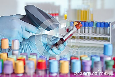 Hands scanning a tube with barcode label for tracking blood samp Stock Photo