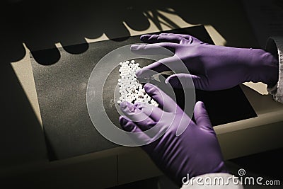 Hands of a scientist working with some pills Stock Photo