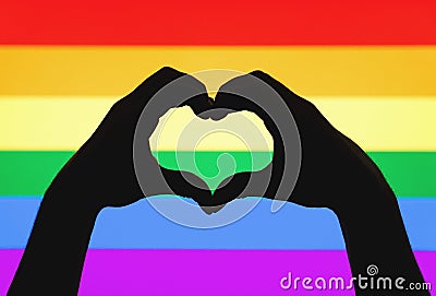 Hands showing heart sign on gay pride and LGBT rainbow flag Stock Photo