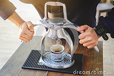 Hands showing making espresso coffee ahot from machine in drinking style Stock Photo