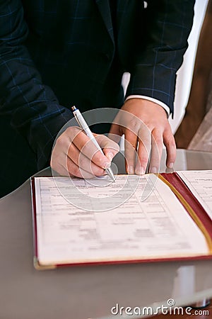 Hands sign a document Stock Photo