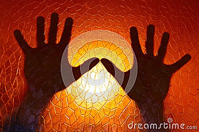 Hands Silhouette on Fire Orange Color Background Stock Photo