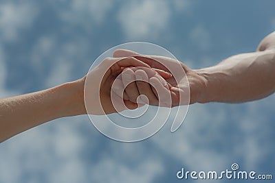 Hands on sky background. Humanity and mutual aid. Friendship. Stock Photo