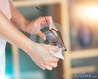 Hands, spectacles and cleaning for sight, vision or eyewear hygiene to see clearly with sanitizing wipe. Hand of person Stock Photo