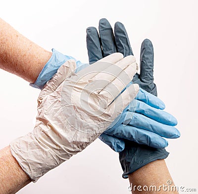 3 hands stacked with PPE gloves Stock Photo