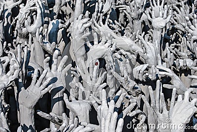 Hands statue from hell in Wat Rong Khun. Wat Rong Khun is a white temple close to Chiang Rai Stock Photo