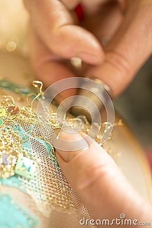 Hands Stitching Gold-Threaded Embroidery Stock Photo