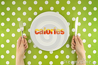 Hands at the table with calories on plate Stock Photo