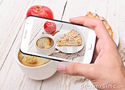 Hands taking photo apple cake with smartphone Stock Photo