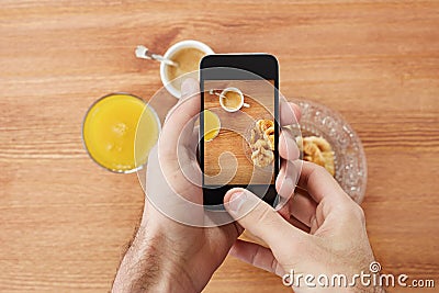 Hands taking photo of breakfast with smartphone Stock Photo