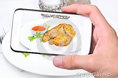 Hands taking photo chicken with smartphone Stock Photo