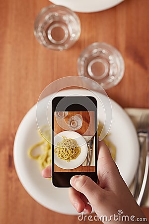 Hands taking photo of lunch with smartphone Stock Photo