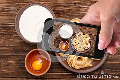 Hands taking photo pasta with smartphone. Stock Photo