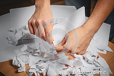 Hands tear paper. overstrain, nerves, psychosis Stock Photo