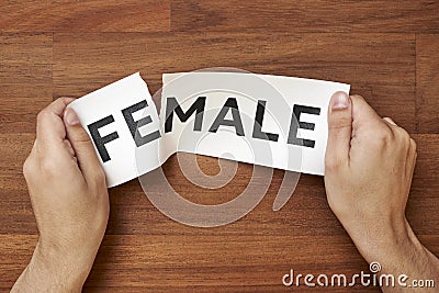 Hands tearing the word female, leaving male. Gender identity concept Stock Photo