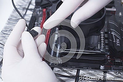 Hands of a technician assembling computer hardware parts new cpu is being mounted unto the motherboard Stock Photo