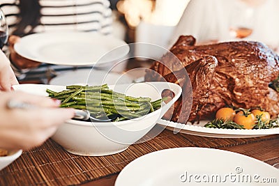 Hands, thanksgiving turkey or green beans food on dining table in holiday celebration, social gathering or lunch party Stock Photo