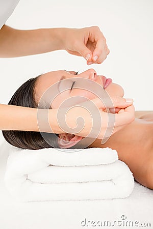 Hands threading beautiful womans face Stock Photo