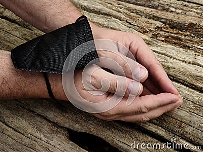 hands tied with FPP-2 medical mask on a wooden surface Stock Photo