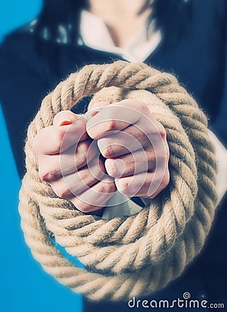 Hands tied with rope Stock Photo