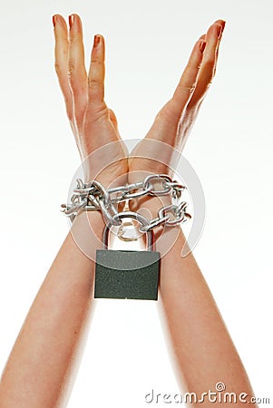 Hands tied up with chains Stock Photo