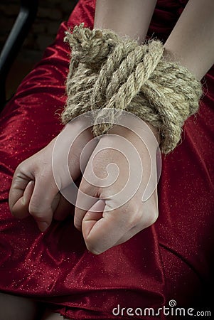 Hands tied up with rope Stock Photo