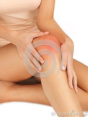 Hands touching knee Stock Photo