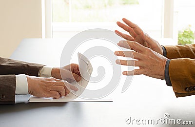 Hands from two businessmen in conversation by a desk. Negotiating business or a job interview. - Image Stock Photo