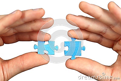 Hands with two puzzles Stock Photo