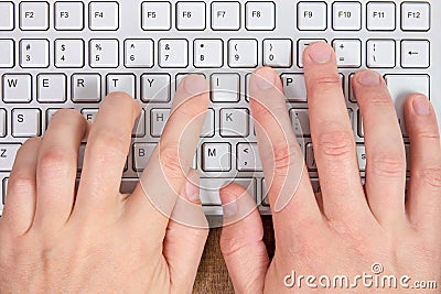 Hands typing on a computer keyboard Stock Photo