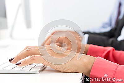 Hands typing on computer keyboards Stock Photo