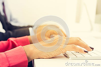 Hands typing on computer keyboards Stock Photo