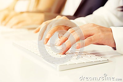 Hands typing on computer keyboards Stock Photo