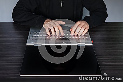 Hands typing on keyboard computer laptop with blank copy-space screen in an office at a workplace. concept of cyber crime and hack Stock Photo