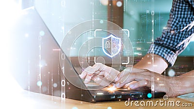 Hands typing on a laptop with a digital shield and lock icon, symbolizing cybersecurity. Surrounded by binary code and glowing Stock Photo