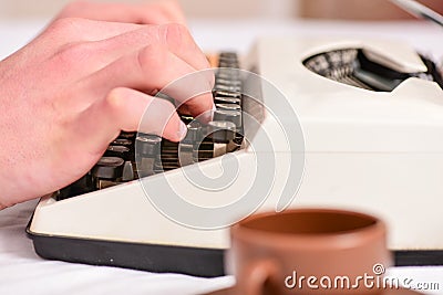 Hands typing retro writing machine. Old typewriter and authors hands. Male hands type story or report using white Stock Photo