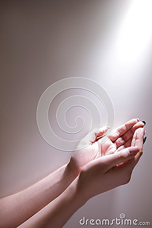 Hands glowing light god grace fervent prayer Stock Photo