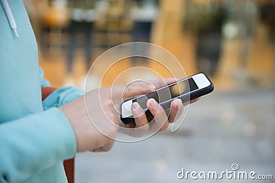 Women use smartphone front of shopwindow Stock Photo