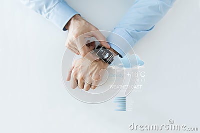 Hands with weather forecast app on smart watch Stock Photo