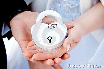 Hands and white lock. Stock Photo