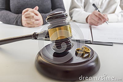 Hands of wife, husband signing decree of divorce, dissolution, canceling marriage, legal separation documents, filing Stock Photo