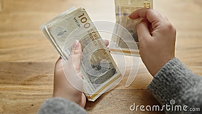 Hands of woman counting hundred denmark krone banknotes at room Stock Photo