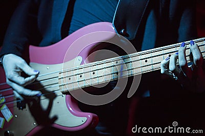 The hands of woman with electric bass Stock Photo