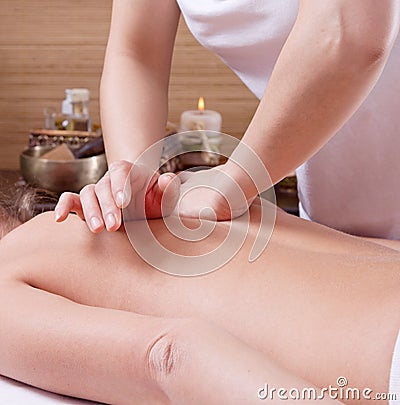 Hands of a woman making massage on a womans back Stock Photo