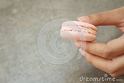 Hands of the woman picked a macaron Stock Photo