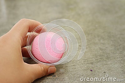 Hands of the woman picked a macaron Stock Photo