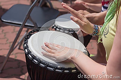 Hands of a woman playing a drum closeup Stock Photo