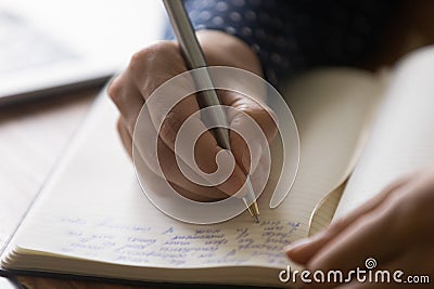 Hands of woman taking notes of online lecture webinar Stock Photo